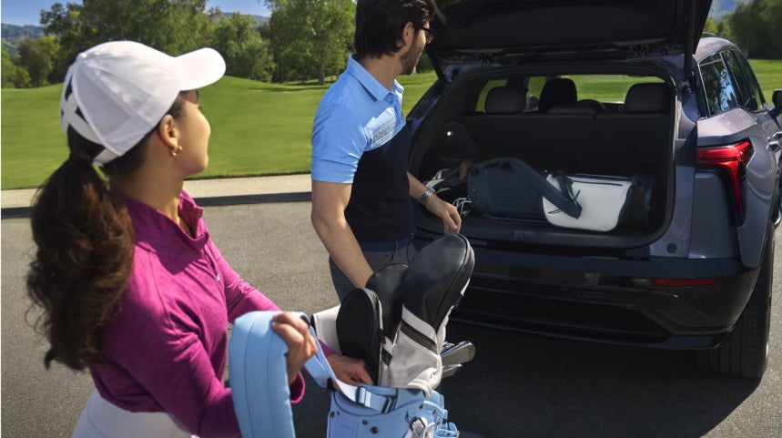 Family putting stuff into SUV Trunk
